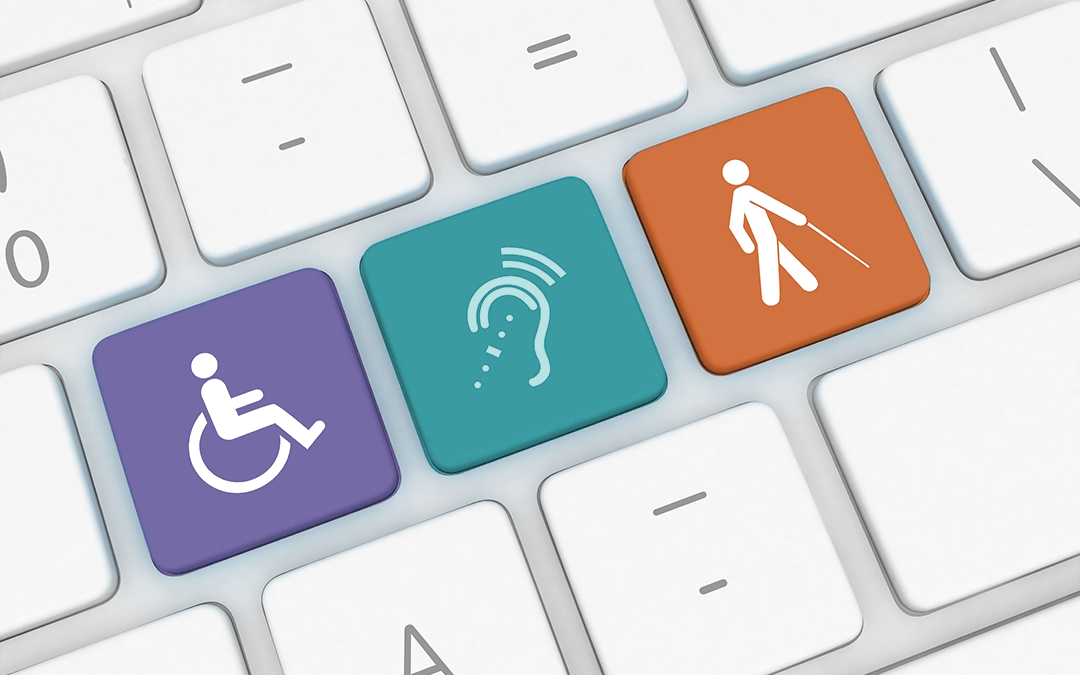 Photo of a keyboard with icons representing physical, hearing and vision disabilities. Photo d'un clavier avec des icônes représentant des handicaps physiques, auditifs et visuels.